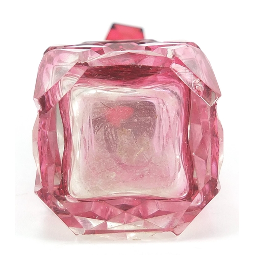 84 - Cranberry cut glass scent bottle with silver collar, London import marks for Simon & Adler, 8cm high