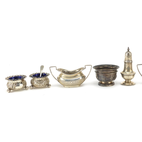 83 - Edwardian and later silver cruets and napkin rings, some with blue glass liners, weighable silver 34... 