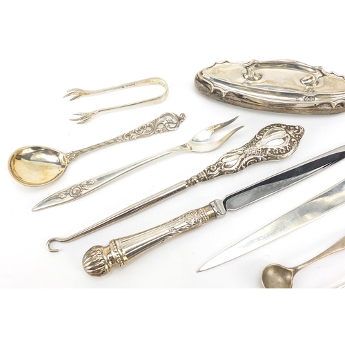 69 - Silver objects including a Maltese letter opener, mustard spoons and sugar tongs, various hallmarks,... 