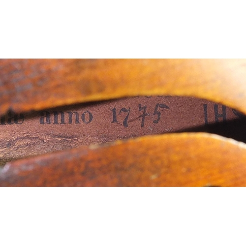 1014 - Old wooden violin with one piece back and case bearing a Joseph Guarnerius Fecit paper label dated 1... 