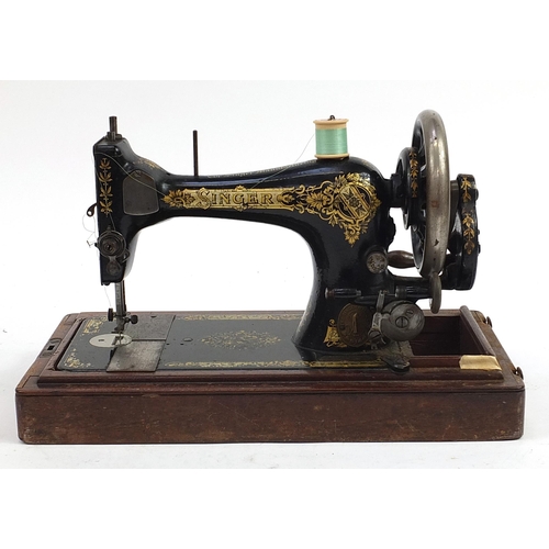 2087 - Victorian black enamel Singer sewing machine with mahogany case, numbered S2293131, 43cm in length