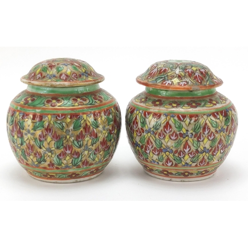 1026 - Pair of Chinese porcelain vases and covers hand painted with flowers, each 7cm high