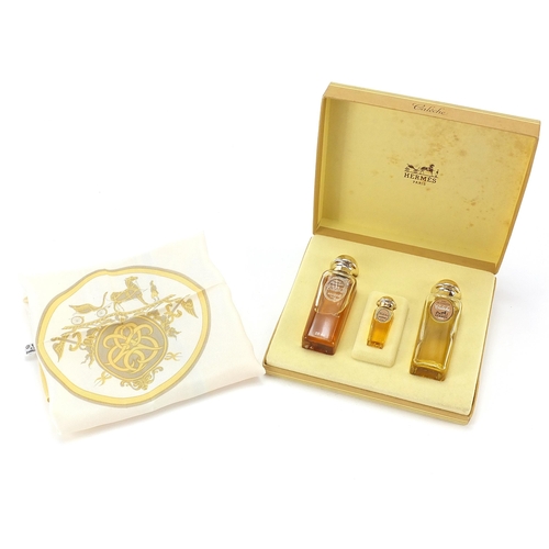 1038 - Set of three Hermes perfumes with fitted box and a Caleche silk handkerchief, 42cm x 42cm