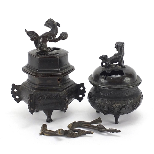 981 - Two Japanese patinated bronze tripod incense burners and covers, the largest 16cm high