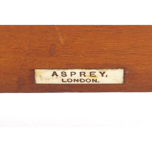 1009 - Miniature mahogany bookshelf housing eight books by Asprey of London, 20.5cm wide