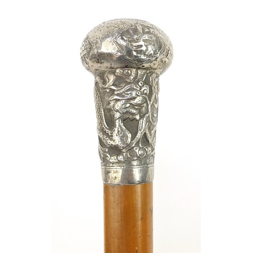 942 - Malacca walking stick with Chinese unmarked silver pommel embossed with a dragon amongst flowers, 96... 