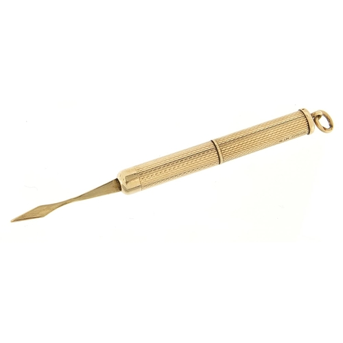 963 - 9ct gold propelling toothpick with engine turned decoration, 5.0cm in length un-extended, 6.6g