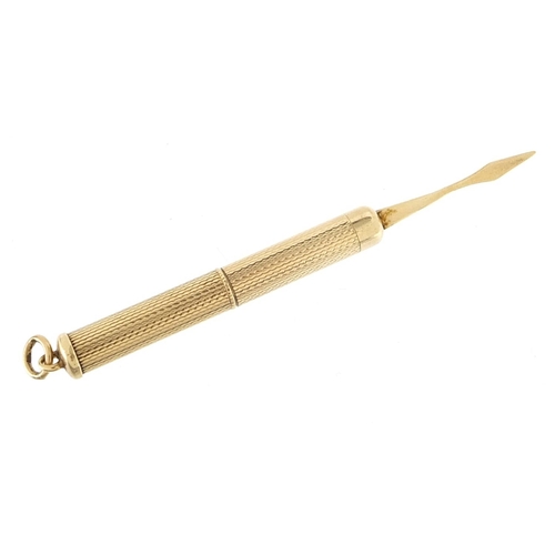 963 - 9ct gold propelling toothpick with engine turned decoration, 5.0cm in length un-extended, 6.6g