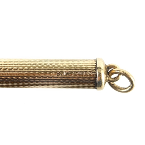 963 - 9ct gold propelling toothpick with engine turned decoration, 5.0cm in length un-extended, 6.6g