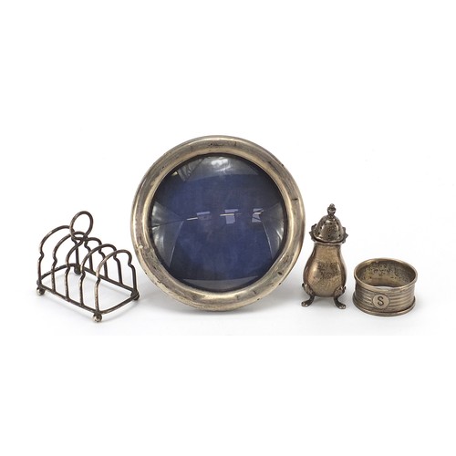 82 - Edwardian and later silver objects including circular easel photo frame, four slice toast rack and c... 