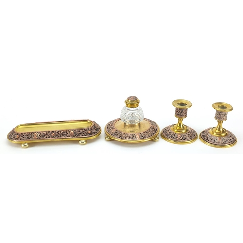 1044 - 19th century continental gilt brass and copper desk set comprising a pen tray, inkwell and pair of c... 