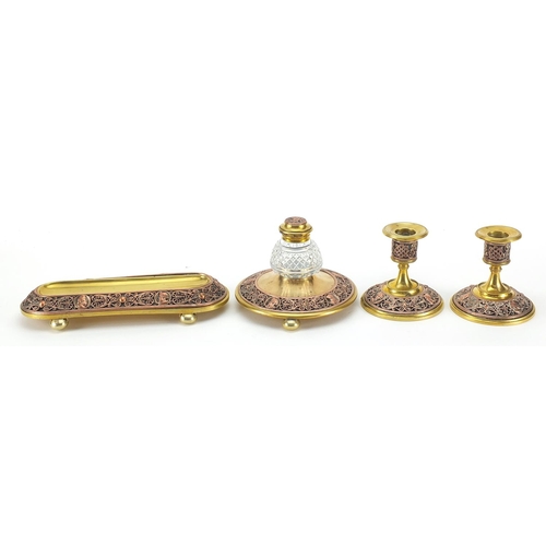 1044 - 19th century continental gilt brass and copper desk set comprising a pen tray, inkwell and pair of c... 