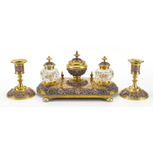 1045 - 19th century continental gilt brass and copper desk set comprising a pair of candlesticks and desk s... 