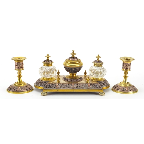 1045 - 19th century continental gilt brass and copper desk set comprising a pair of candlesticks and desk s... 