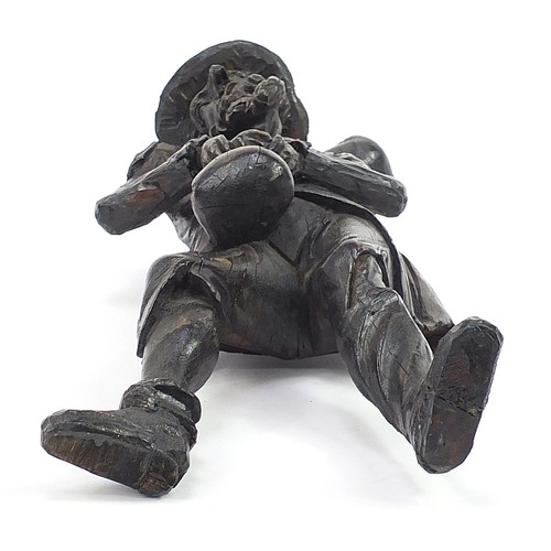 957 - Antique oak carving of a man holding a sack, 61cm high