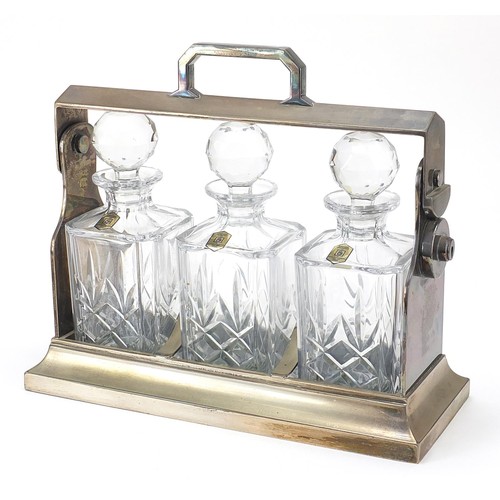 875 - Mappin & Webb Sheffield silver plated tantalus with three crystal decanters, 34cm wide