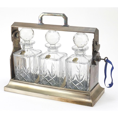 875 - Mappin & Webb Sheffield silver plated tantalus with three crystal decanters, 34cm wide