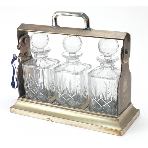 875 - Mappin & Webb Sheffield silver plated tantalus with three crystal decanters, 34cm wide