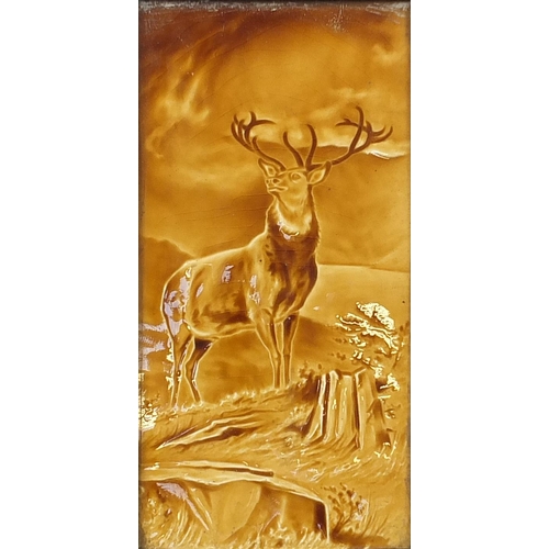 2126 - Large Victorian treacle glazed tile hand painted with a stag, framed, the tile 29cm x 14.5cm excludi... 