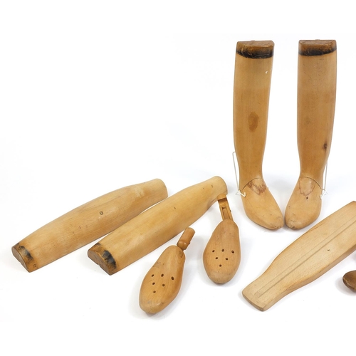 1995 - Pair of light wood boot stretchers and four articulated feet, the largest 61cm in length