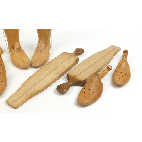 1995 - Pair of light wood boot stretchers and four articulated feet, the largest 61cm in length