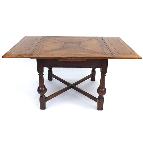 64 - Oak draw leaf dining table with bulbous legs, 76cm H x 92cm W x 92cm D extending to 152cm wide
