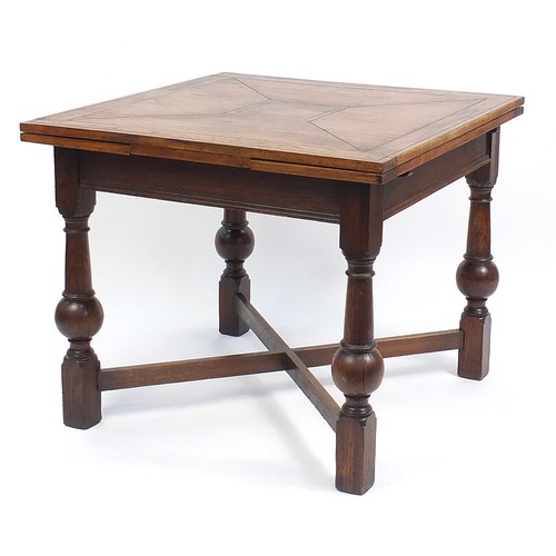 64 - Oak draw leaf dining table with bulbous legs, 76cm H x 92cm W x 92cm D extending to 152cm wide