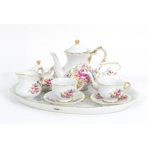 257 - Miniature floral china tea for two set, the tray 25cm in diameter