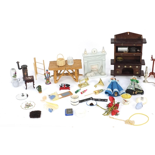 253 - Assorted doll's house furniture including ceramic fireplace, wooden dresser and miniature dolls, the... 