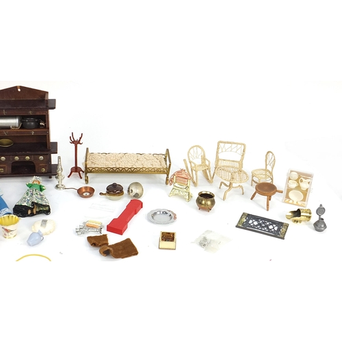 253 - Assorted doll's house furniture including ceramic fireplace, wooden dresser and miniature dolls, the... 