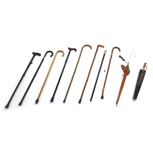 160 - Assorted wooden walking sticks and umbrellas including a Japanese umbrella