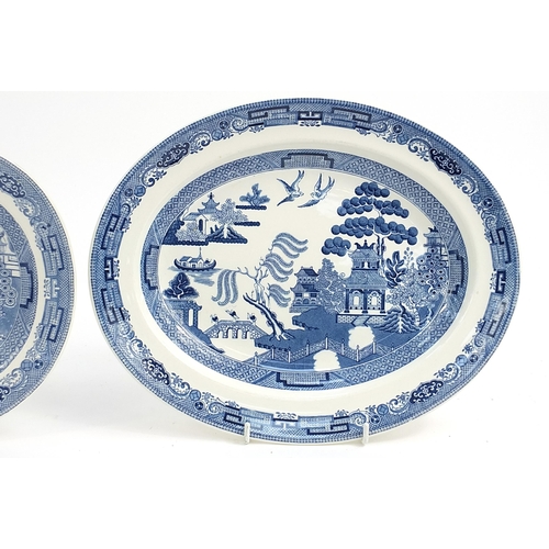 181 - Pair of Wedgwood blue and white Willow pattern meat plates, the largest 32cm wide