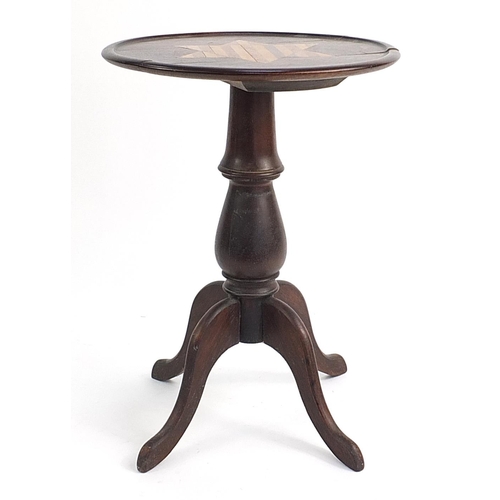 83 - Mahogany occasional table with a star shaped inlaid motif top on a tripod base, 60cm tall