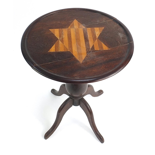 83 - Mahogany occasional table with a star shaped inlaid motif top on a tripod base, 60cm tall