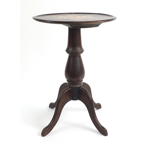 83 - Mahogany occasional table with a star shaped inlaid motif top on a tripod base, 60cm tall