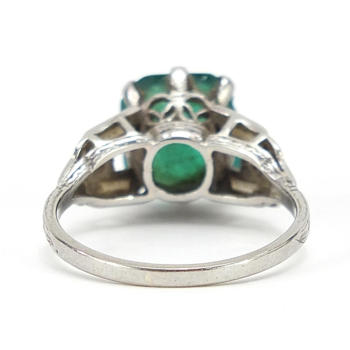 61 - Art Deco platinum emerald ring with diamond set shoulders, the emerald 10mm H x 9.3mm W x 4.1mm D, s... 
