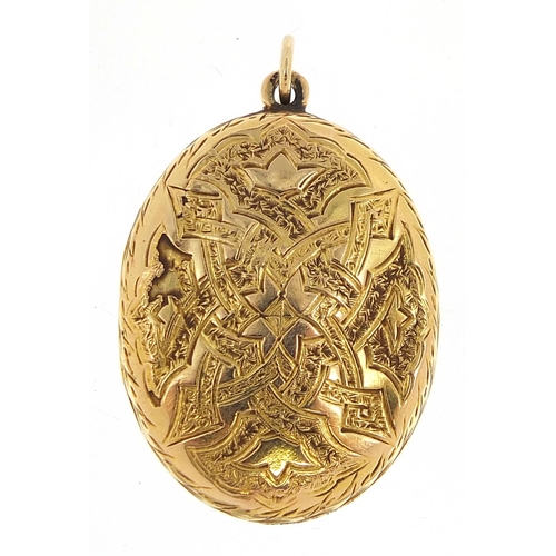 117 - Unmarked gold oval locket with engraved decoration, 3.2cm high, 7.7g