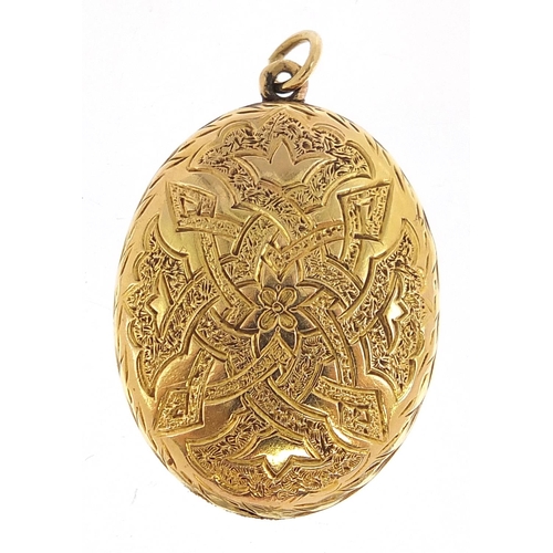 117 - Unmarked gold oval locket with engraved decoration, 3.2cm high, 7.7g