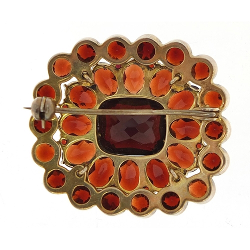 147 - Gilt metal three tier Bohemian garnet cluster brooch, 3.1cm wide, 10.4g