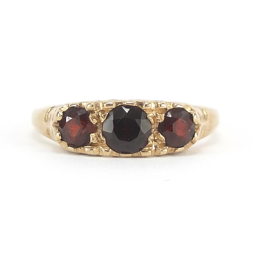 349 - 9ct gold garnet three stone ring, size O, 2.5g