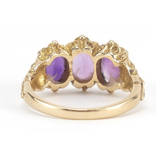 80 - 9ct gold amethyst three stone ring with ornate shoulders, size M, 3.9g