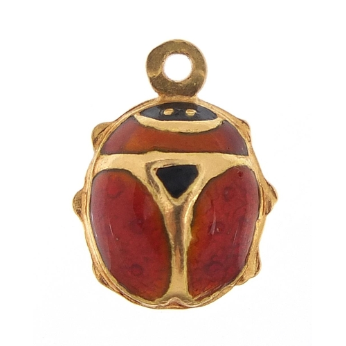 257 - 18ct gold and enamel ladybird charm, 1.3cm in length, 0.8g