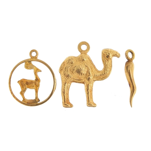 177 - Three unmarked gold charms including a camel and horn of plenty, the largest 1.8cm high, total 2.3g