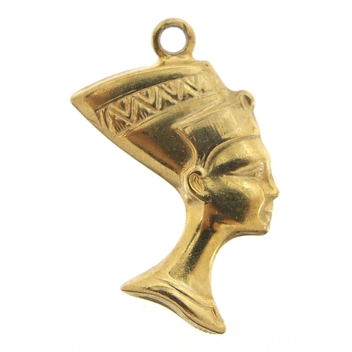 219 - Unmarked gold Nefertiti charm, (tests as 9ct gold) 2.2cm high, 0.8g