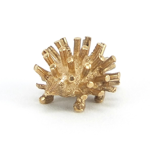 233 - Unmarked gold hedgehog charm, (tests as 9ct gold) 1.2cm in length, 1.0g