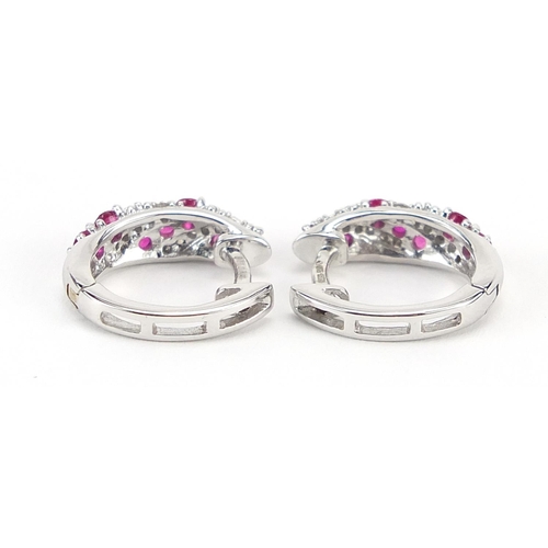 125 - Pair of 9ct white gold ruby and diamond hoop earrings, 1.2cm in diameter, 2.9g