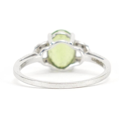 123 - 9ct white gold peridot and diamond ring, size O, 1.9g