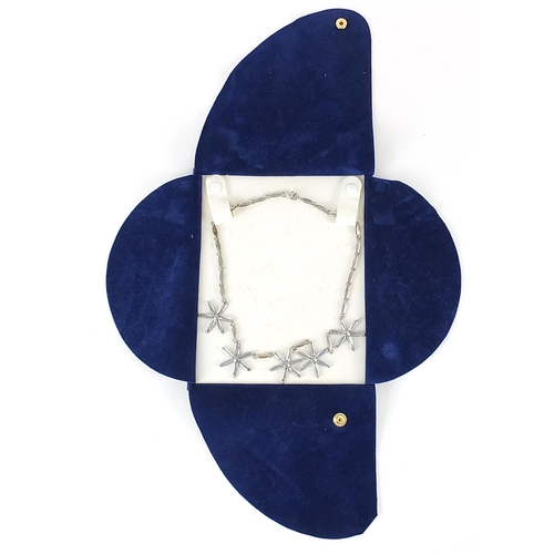 253 - Modernist silver flower head necklace set with blue stones, 40cm in length, 26.2g