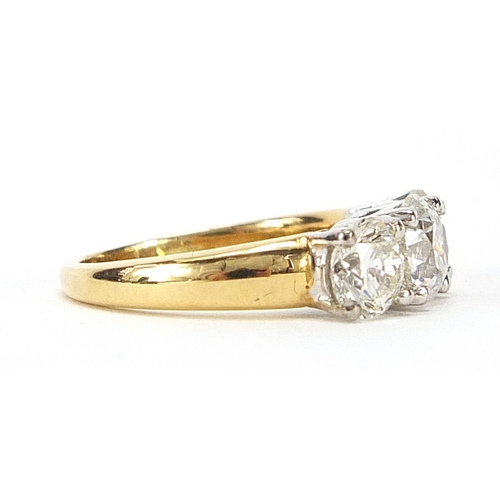 7 - 18ct gold diamond three stone ring, the central diamond weighing 0.96ct flanked by two diamonds each... 