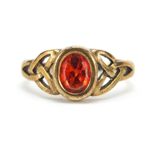 229 - 9ct gold orange stone ring with Celtic design shoulders, size M, 3.1g